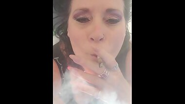Mature W/ big feet in slippers sunbathes her pussy while smoking POV